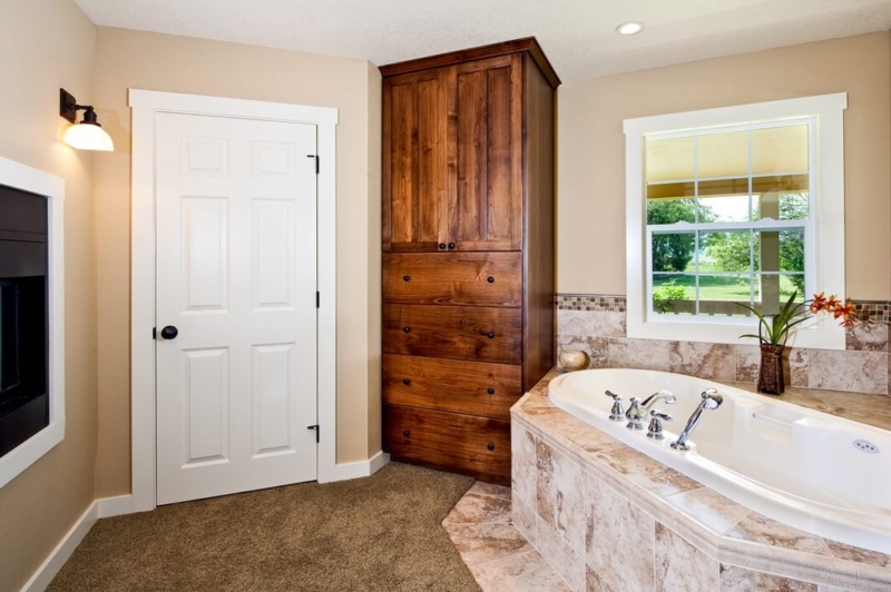 The master bathroom with a jetted soaking tub and see-through fireplace.