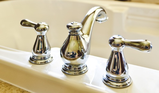 A polished nickel delta tub filler faucet is featured in this bathroom remodeling project.