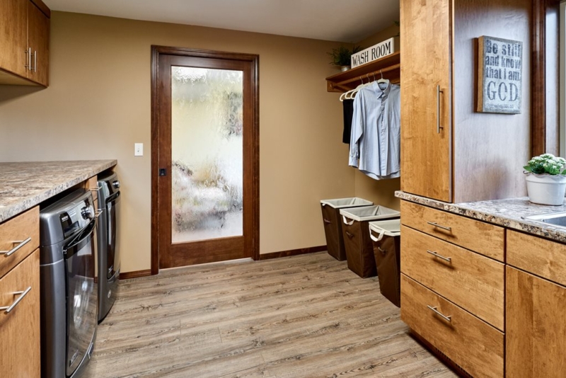 laundry room with dark wood floors and frosted glass door 