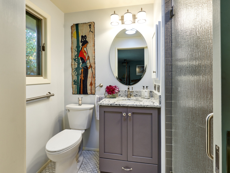 custom cabinetry in contemporary bathroom gray vanity with stone countertop and white tile floor
