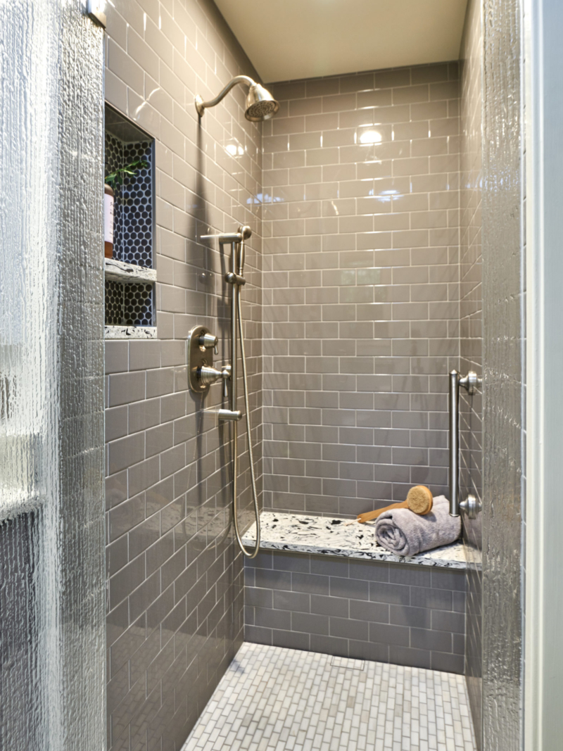 updated contemporary bathroom gray subway tile shower with niche and bench