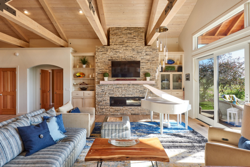 stone fireplace with horizontal timber beams on ceiling 