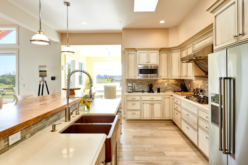 white glazed farmhouse kitchen with hammered copper sink 