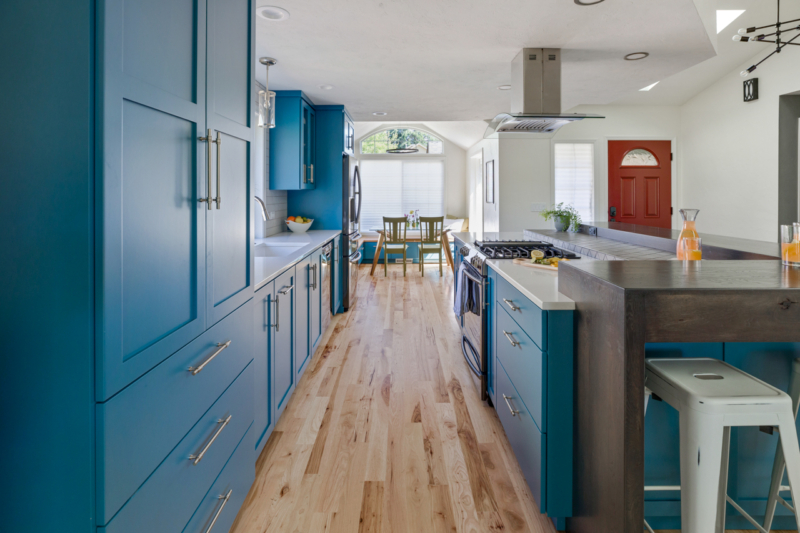 View down the middle of the kitchen with cabinets on both sides 