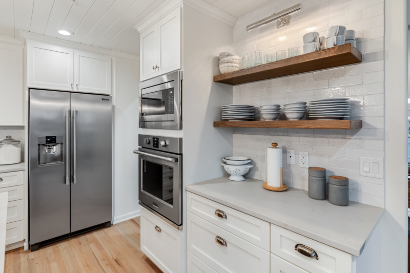 Open shelves in redesigned kitchen Open shelves above white cabinets and countertops