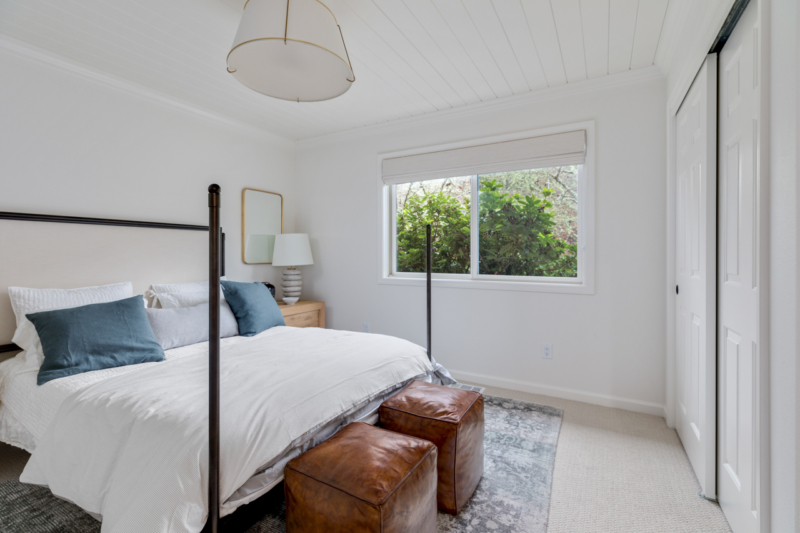 White bedroom with decorative accents on bed and nightstands 