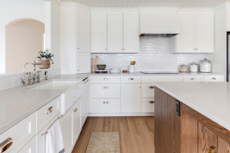 White cabinetry in farmhouse kitchen Bright modern white bathroom with dual sinks
