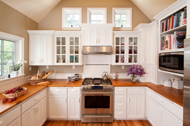 Cape Cod addition and kitchen by Powell Construction Contemporary kitchen with white cabinets and island