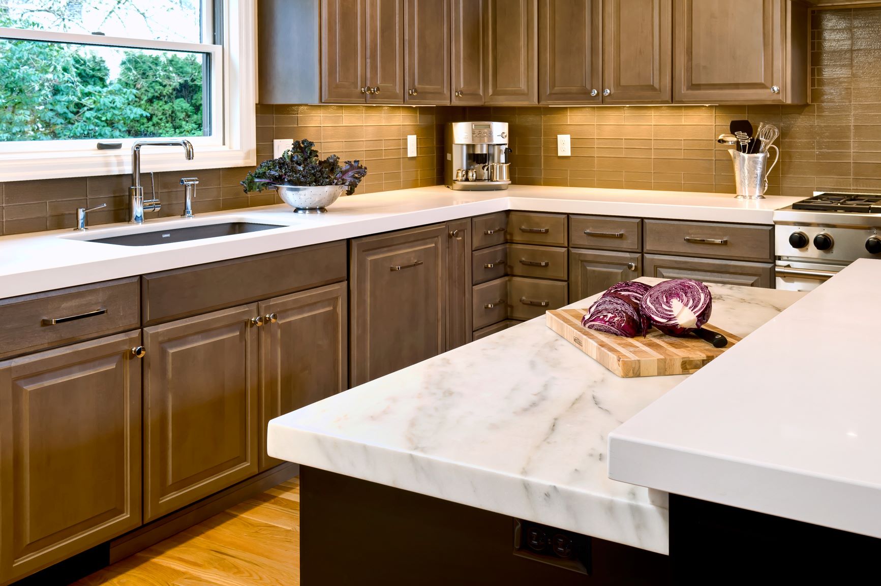 Distinct work stations for multiple cooks include this marble counter for pastry.
