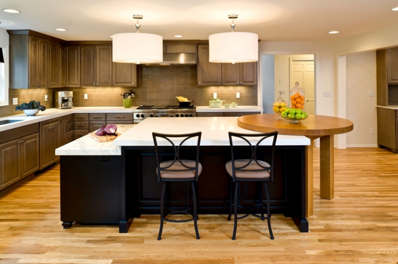 Multi-level island accommodates a variety of tasks. Modern kitchen with straight layout
