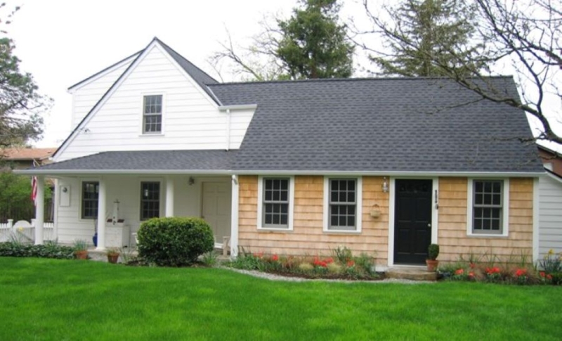 Cape cod addition with white siding and cedar accent siding Cape cod addition with white siding and cedar accent siding