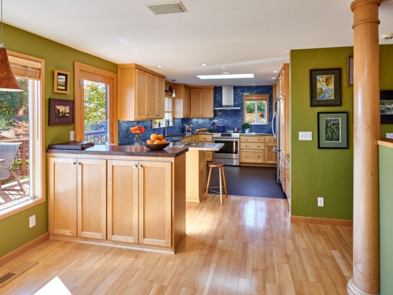 Kitchen remodel replaces counters, appliances, and flooring A new kitchen design with custom maple cabinets and handmade blue tile