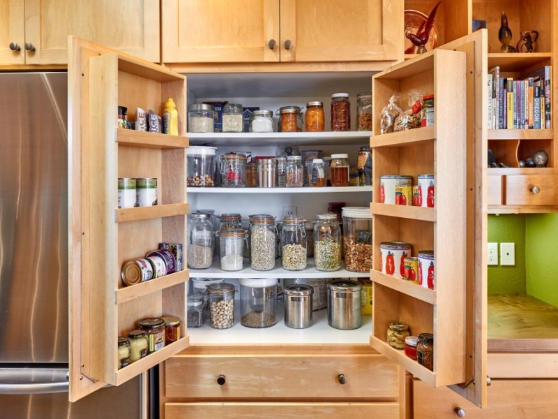 Fresh kitchen with remodeled cabinets Custom pantry with door storage for canned goods