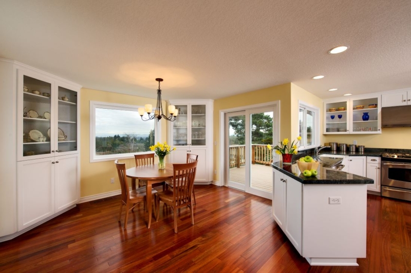 A dining room addition and newly remodeled yellow kitchen.