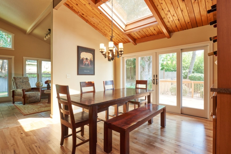Dining area remodel to create open concept floorplan The new great room features skylights and a vaulted, wood-paneled ceiling.