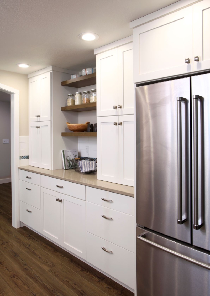 The redesigned contemporary kitchen combines open shelves and enclosed storage.