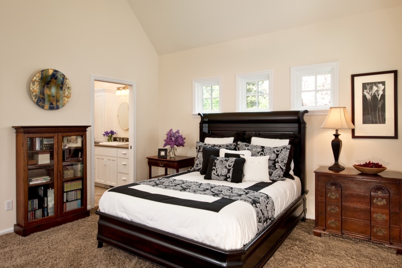 Cape Cod addition and kitchen by Powell Construction The master bedroom has an adjoining bath and walk-in closet.