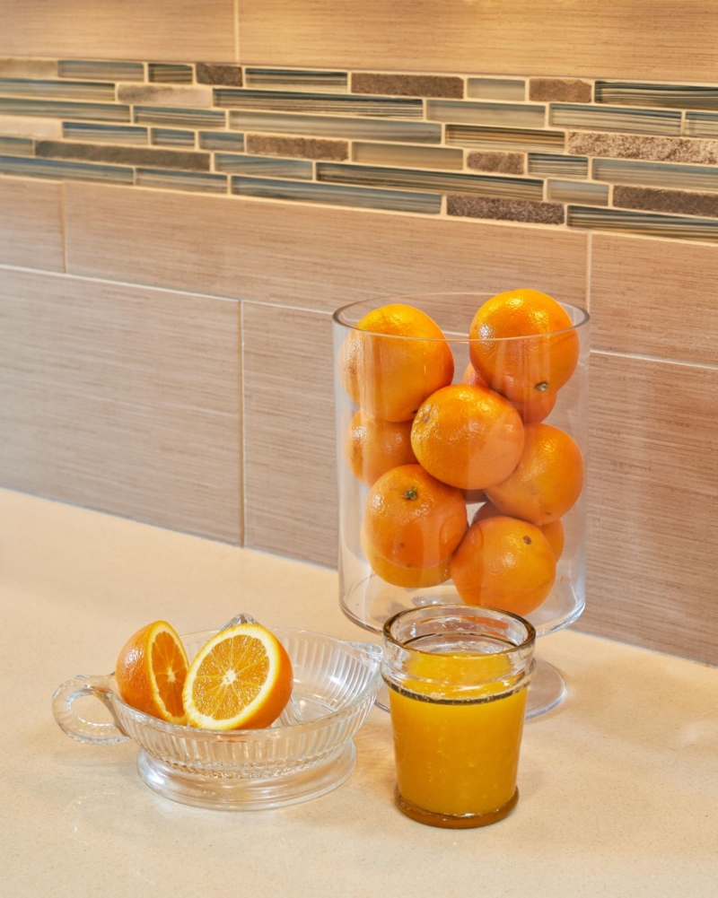 Xenon undercabinet lighting shows off the Caesarstone counters and tile backsplash in this Caesarstone Kitchen Remodel. Kitchen backsplash tile detail