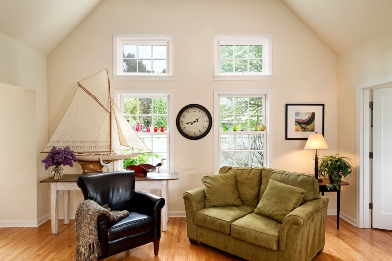 This sitting room has a vaulted ceiling and a nautical theme with a schooner.