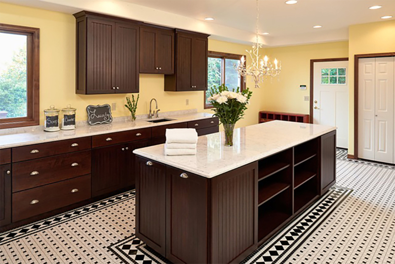 An expansive laundry remodel with black and white tile floor and yellow paint. An expansive laundry remodel with black and white tile floor and yellow paint.