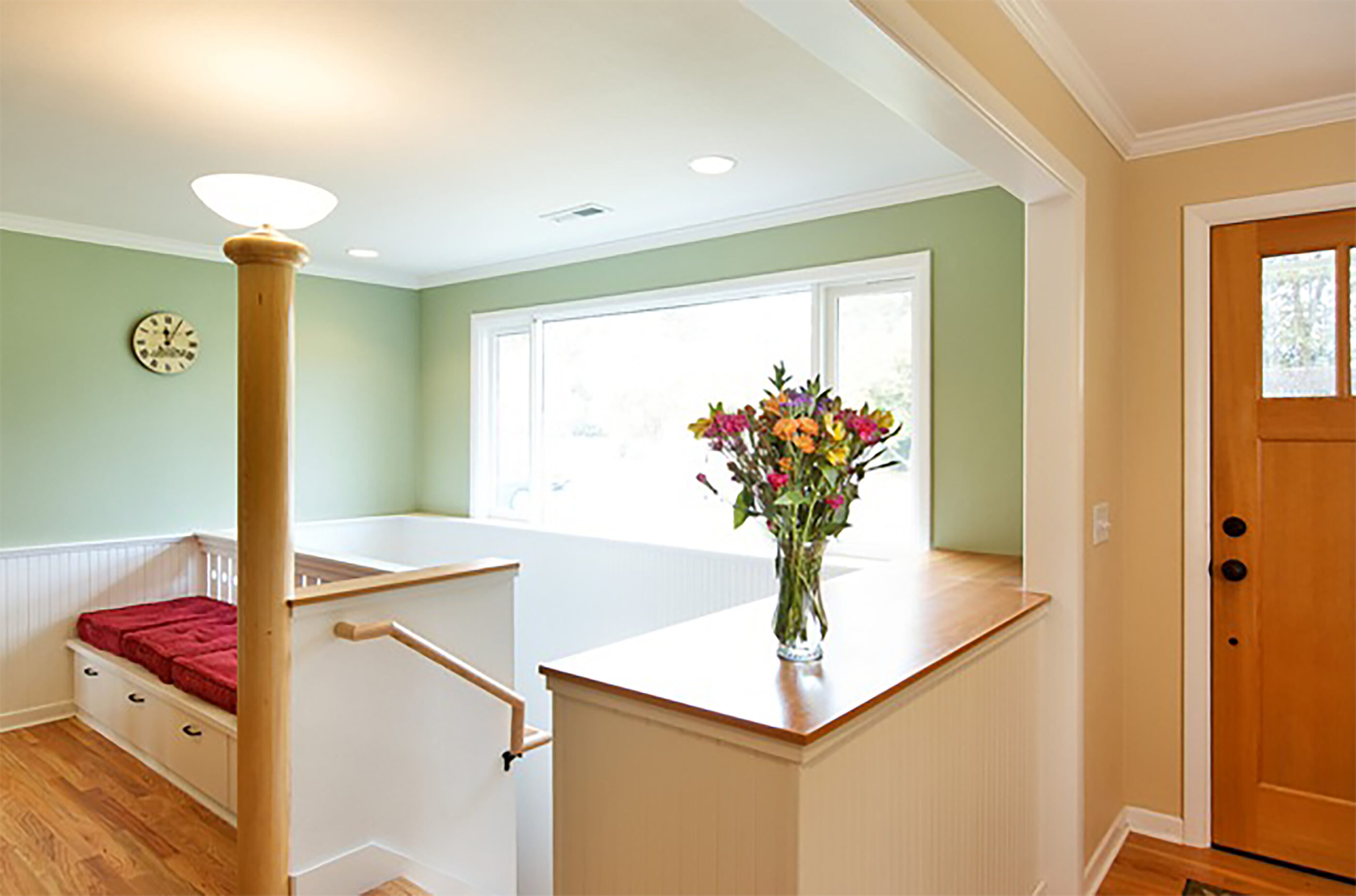 Finishing touches in this eco-friendly renovation include a custom newel lamp post, hand crafted trim.