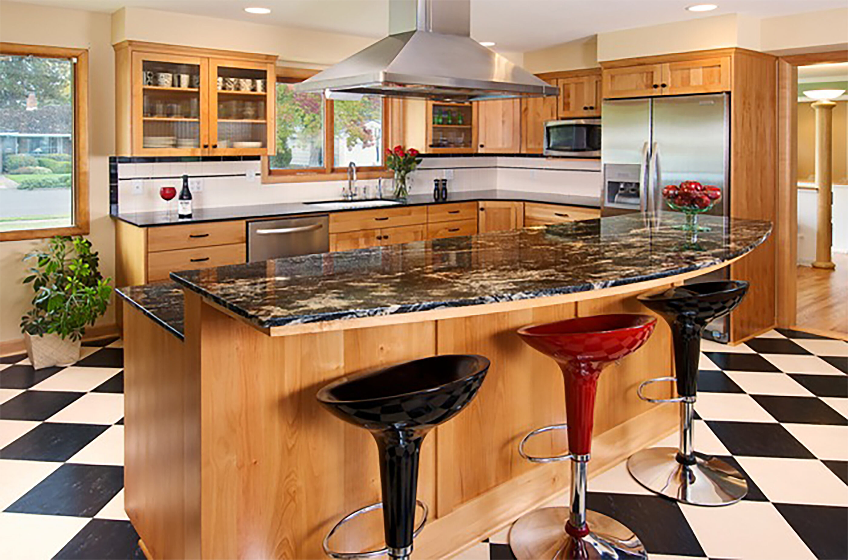 Striking barstools and granite countertops create a nice focal point in this kitchen remodel.