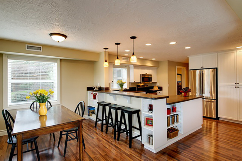 This daylight basement remodel features a kitchen with an eating bar. This daylight basement remodel features a kitchen with an eating bar.