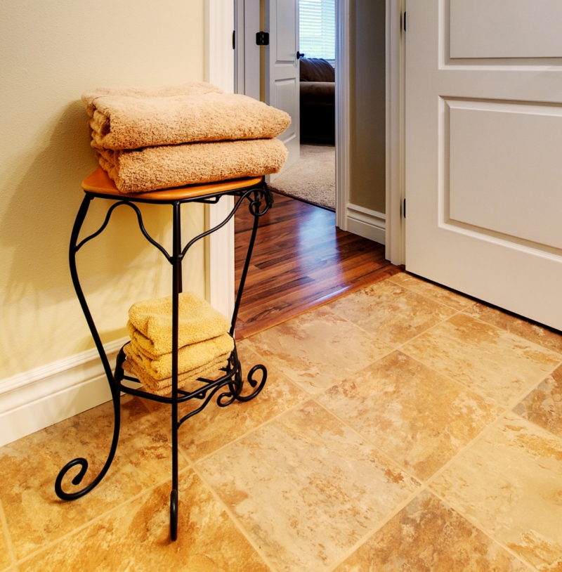 Wilsonart maple laminate flooring for the hallway. Tile is shown on the bathroom floor and Wilsonart maple laminate flooring for the hallway.