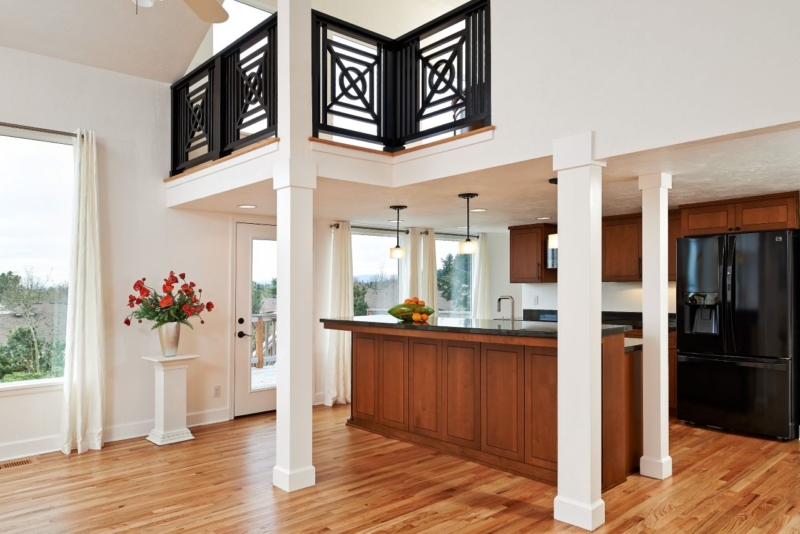 INTERIOR 4 - LOFT AND KITCHEN_large Loft with black railing in geometric pattern above kitchen.