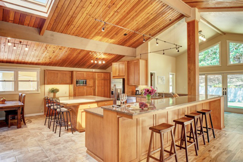 Kitchen design with an eating bar featuring Quantra “Truffle” quartz countertops. Kitchen design with an eating bar featuring Quantra “Truffle” quartz countertops.