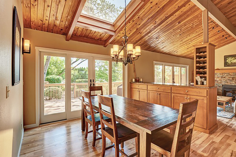 Dining area of newly remodeled space with skylights above and many windows. Dining area of newly remodeled space with skylights above and many windows.