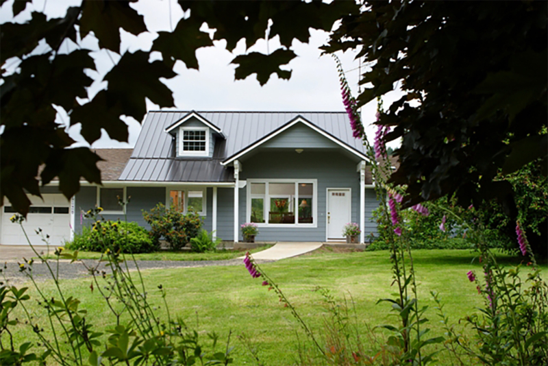 The change to the roofline and the addition of a gable over the front door gives the exterior more of a presence. Raising the roof during home construction
