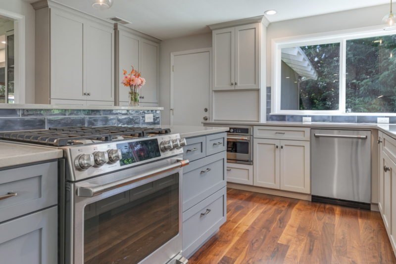 Stainless-steel gas range in large kitchen island. Stainless-steel range in kitchen island
