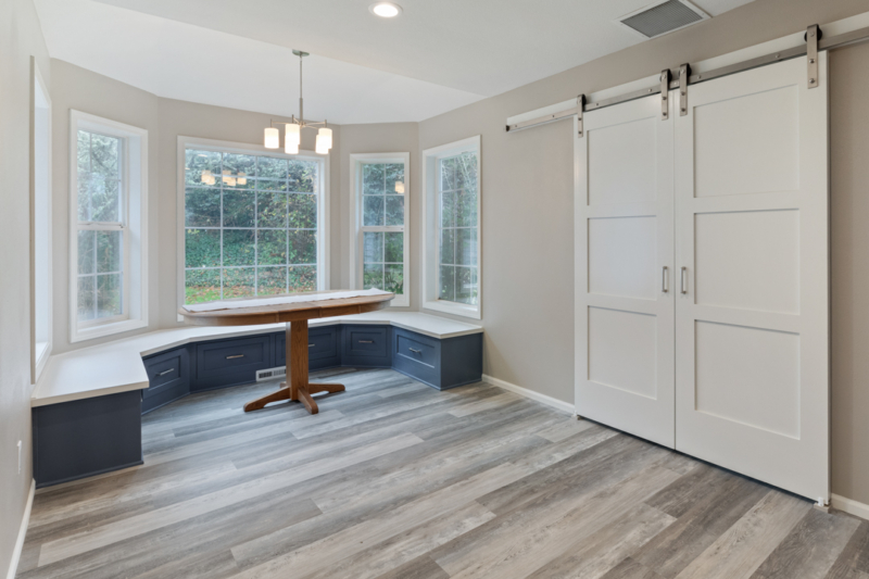 Luxury vinyl plank in dining room with built-in bench seating. Dining room with built-in bench seating and storage below.