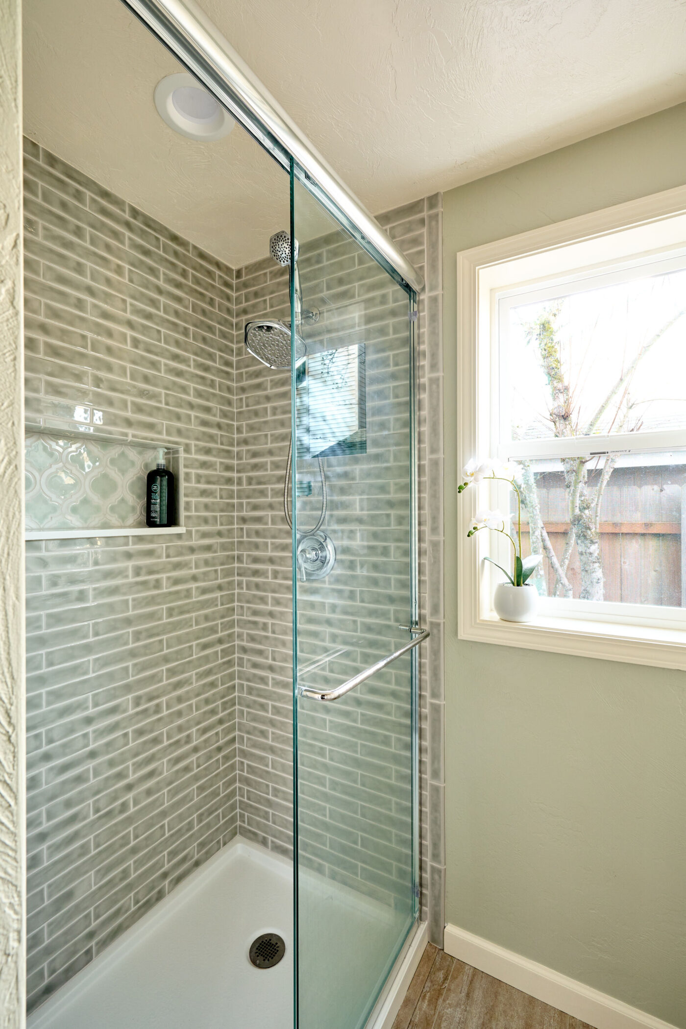 Ceramic tiling and glass shower enclosure in guest bath addition by Powell Construction of Corvallis OR