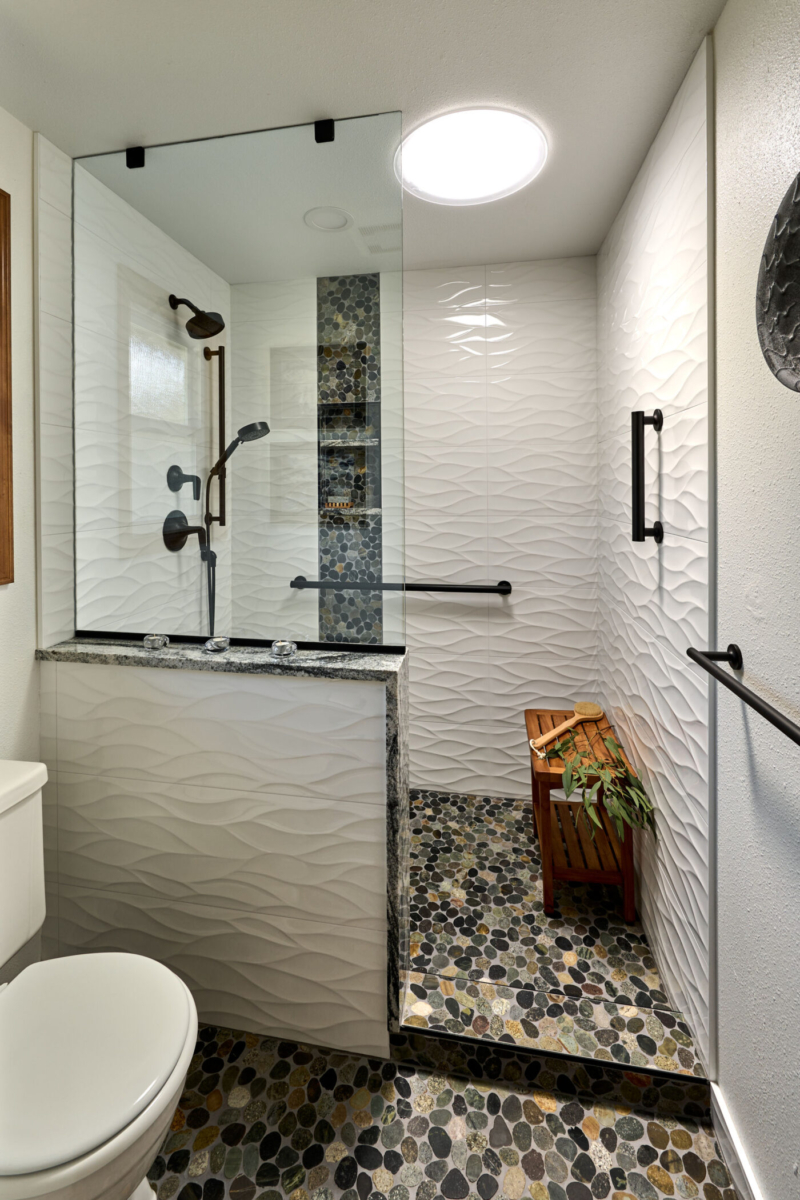 stone floor tiling-large format white tile-solar tube-bathroom remodel-Corvallis OR-Powell Construction Artistic home interior photo with natural light