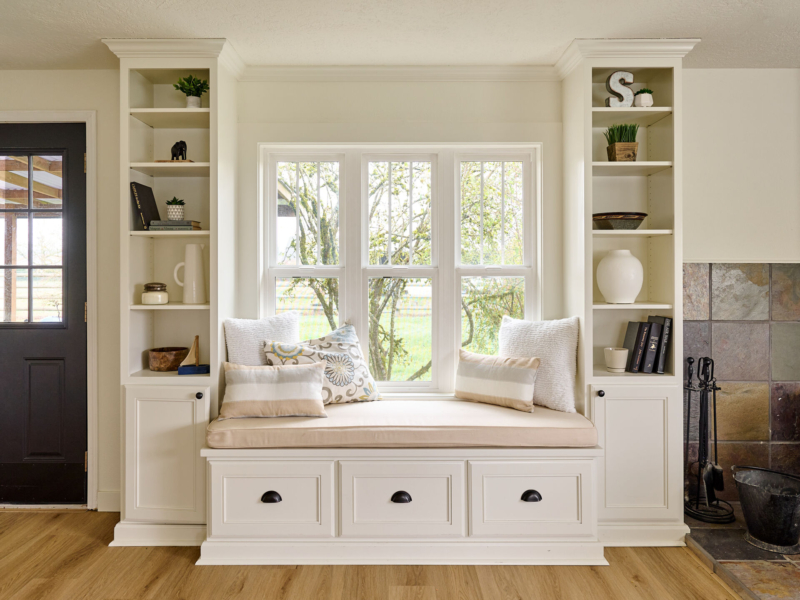 Charming window seat with storage and bookcase display. Window seat with bookcases on each side designed by Powell Construction in Corvallis