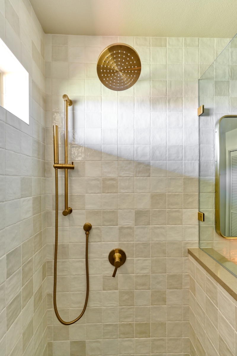 Brushed gold plumbing fixtures in guest bath Brushed gold plumbing fixtures in guest bath remodel by Powell Construction