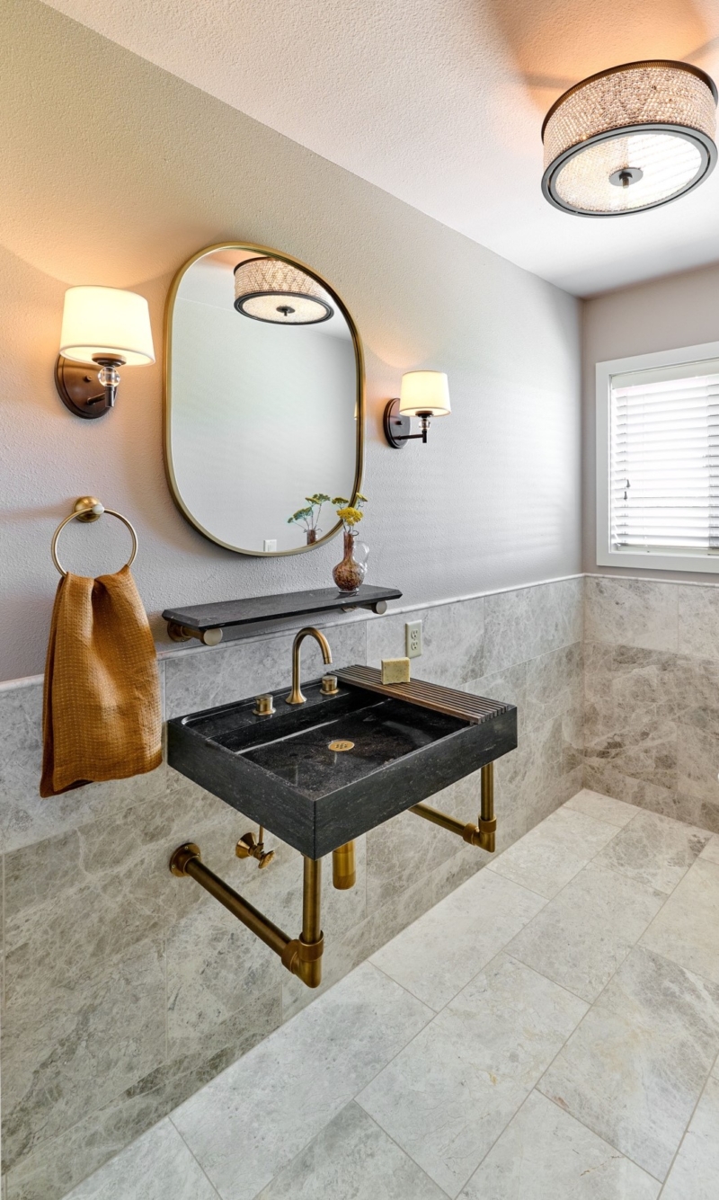 Elegant powder room with marble wainscoting Elegant powder room with marble wainscoting by Powell Construction