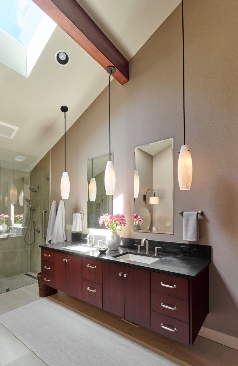 Long pendant lights emphasize tall ceilings Long pendant lights emphasize tall ceilings in this primary bathroom by Powell Construction