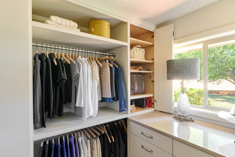 Luxurious walk in closet in primary suite (2) Walk in closet with a designated space for all the accessories by Powell Construction