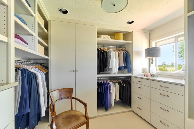 Spacious walk in closet in primary suite Spacious walk in closet in primary suite remodel by Powell Construction