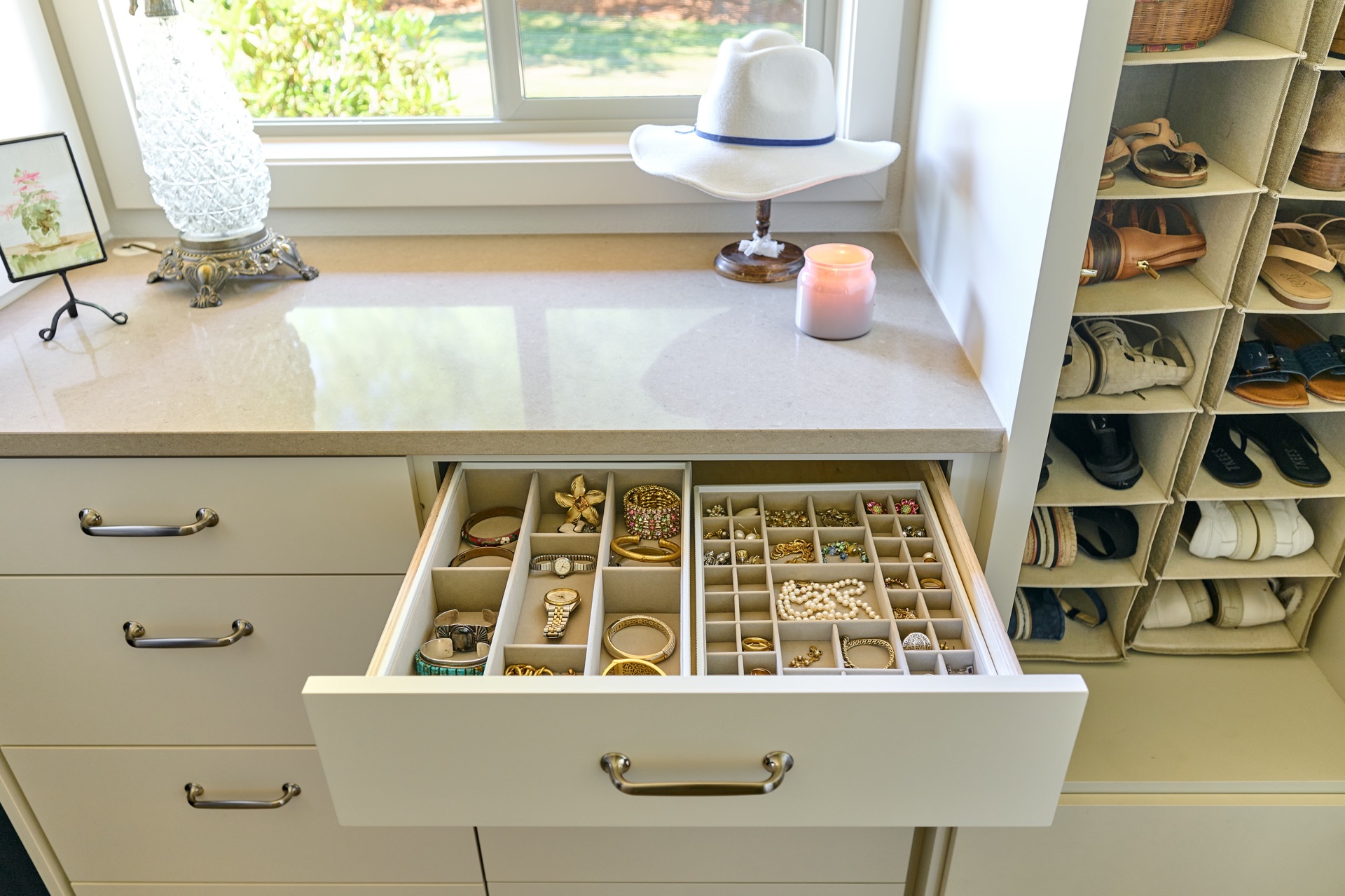 Walk in closet features custom accessory drawer by Powell Construction