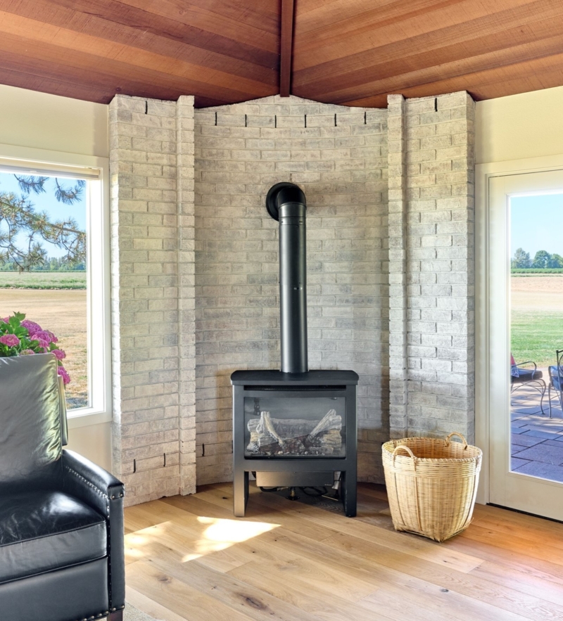 whitewashed brick behind woodstove White washed brick behind cozy woodstove updates the look in this family room