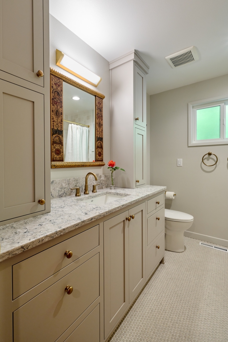 Warm greige cabinetry in this bathroom remodel echoes the paint selection for the kitchen cabinets.