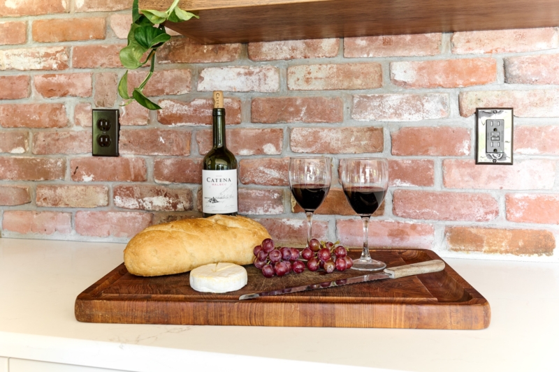 Brick backsplash is a rustic backdrop.
