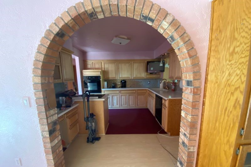 Arched brick entry to kitchen, before remodel.
