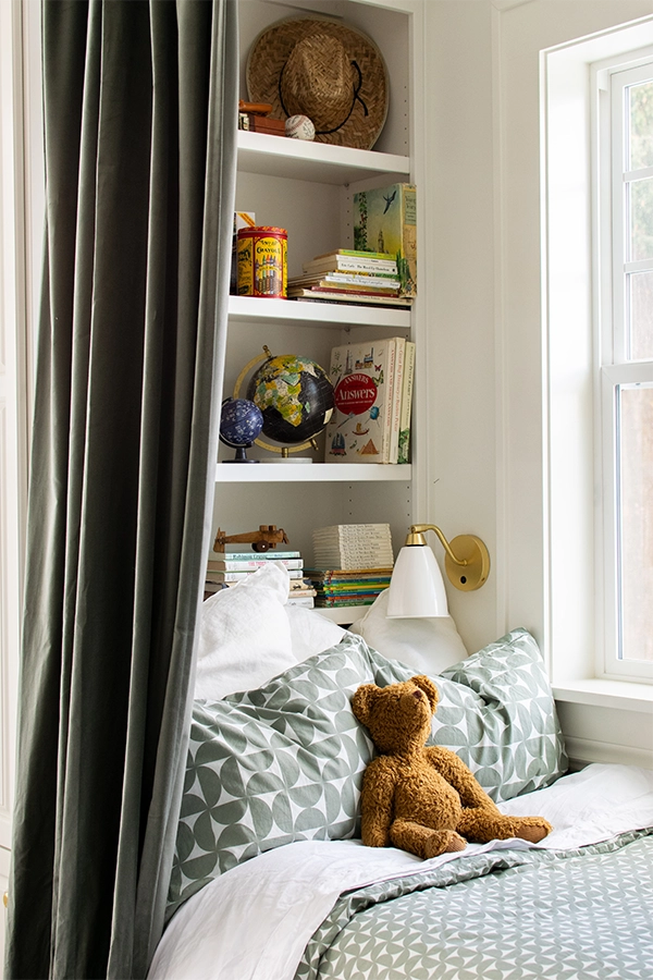 Bunk with toys and books displayed on built In bookcase