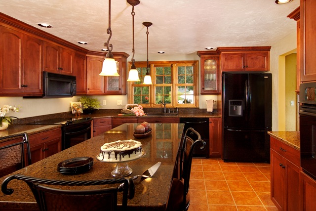 Large island in this traditional cherry kitchen remodel by Powell Construction