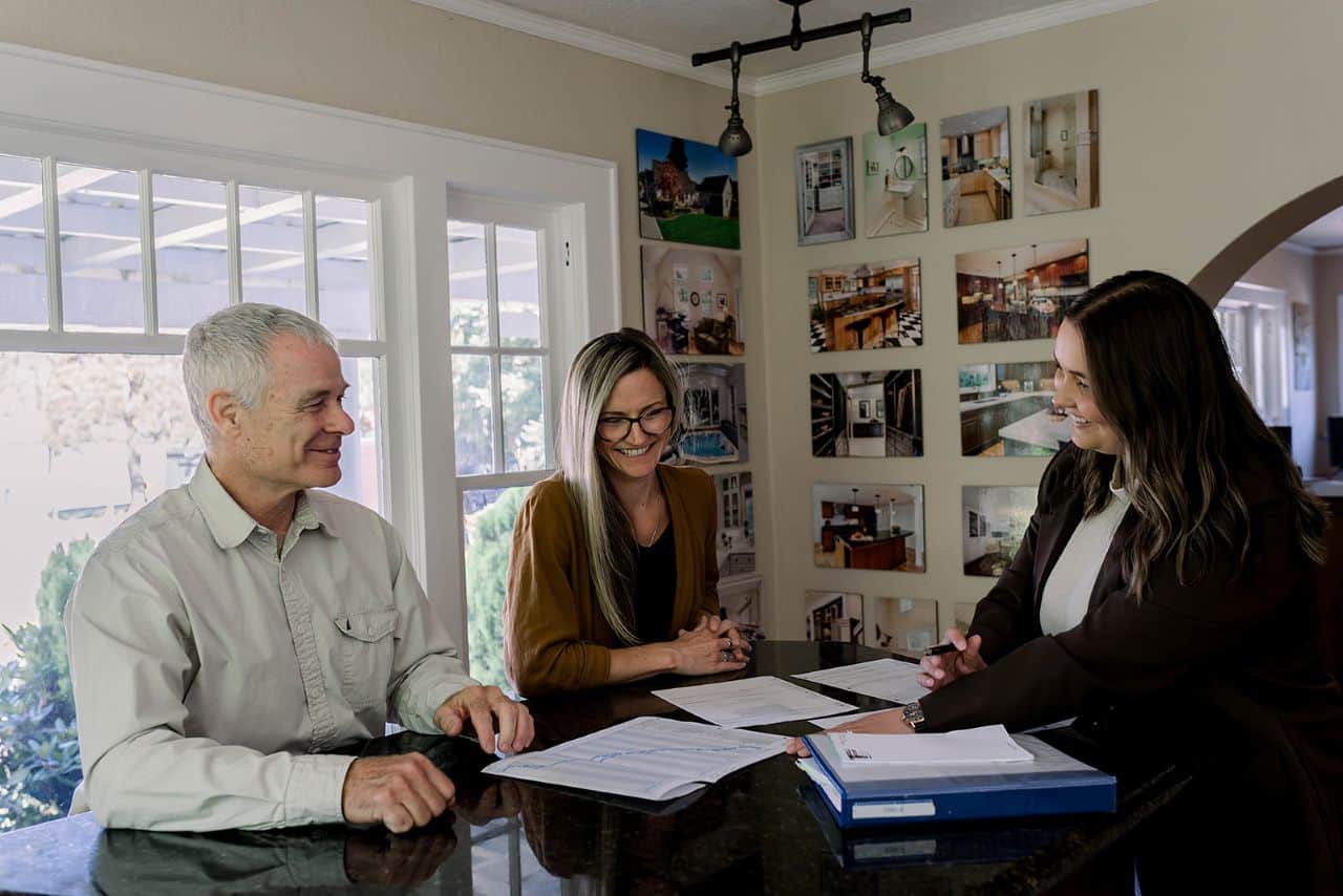 Photo of Powell Construction owner and designer meeting with a customer to discuss remodeling plans.